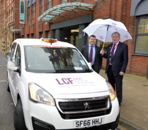 Simon Stell and Roger Raper of LCF Law outside 33 Park Place with LCF Branded taxi
